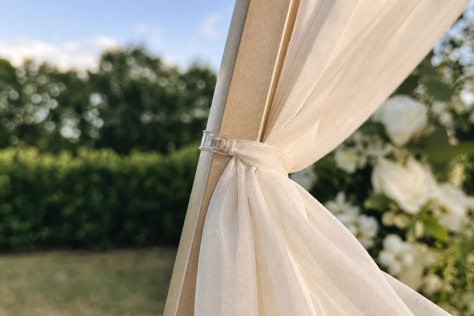 Ivory drape attached to a champagne-gold metal tube